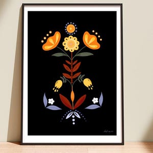 May include: A framed wall art print featuring a symmetrical floral illustration on a black background. The design includes orange and yellow flowers, dark red leaves, and light blue accents arranged in a vertical, stylized botanical pattern.