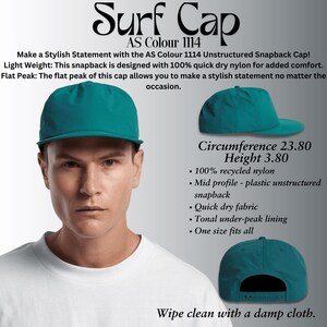 May include: A teal unstructured baseball cap with a flat brim. The cap is made of 100% recycled nylon and has a quick dry fabric. The text "Surf Cap" and "AS Colour 1114" is printed on the cap. The cap is shown on a person wearing a white t-shirt.