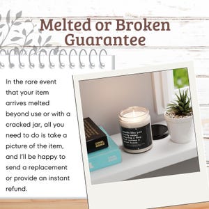 May include: A white candle jar with a black label that reads "smells like you really enjoy walking a tiny green lawn." The candle is lit and sitting on a white shelf with a small potted succulent plant next to it. The text "Melted or Broken Guarantee" is written in brown letters on a white wooden background.