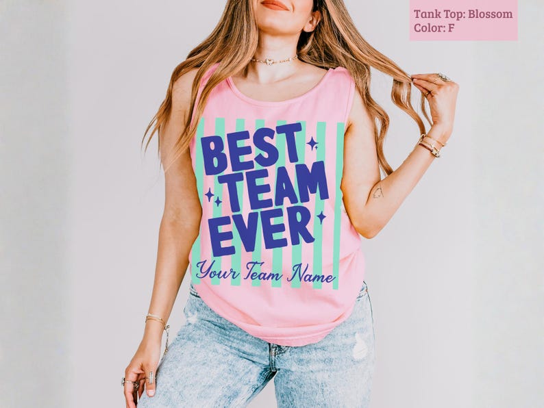 Pink tank top with "BEST TEAM EVER" in blue and green stripes.