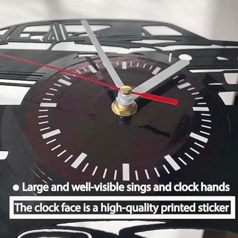 May include: A black and white vinyl record clock featuring a silhouette of a car. The clock face has large, easy-to-read numbers and hands. The clock face is a high-quality printed sticker. "Large and well-visible sings and clock hands. The clock face is a high-quality printed sticker."