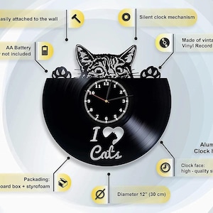 May include: Black vinyl record clock with a cat design and the words "I love Cats". The clock has aluminum hands and a high-quality sticker clock face. The clock is 12 inches in diameter.