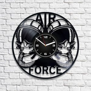 May include: Black vinyl record clock with a design of two pilot helmets and the words "AIR FORCE".