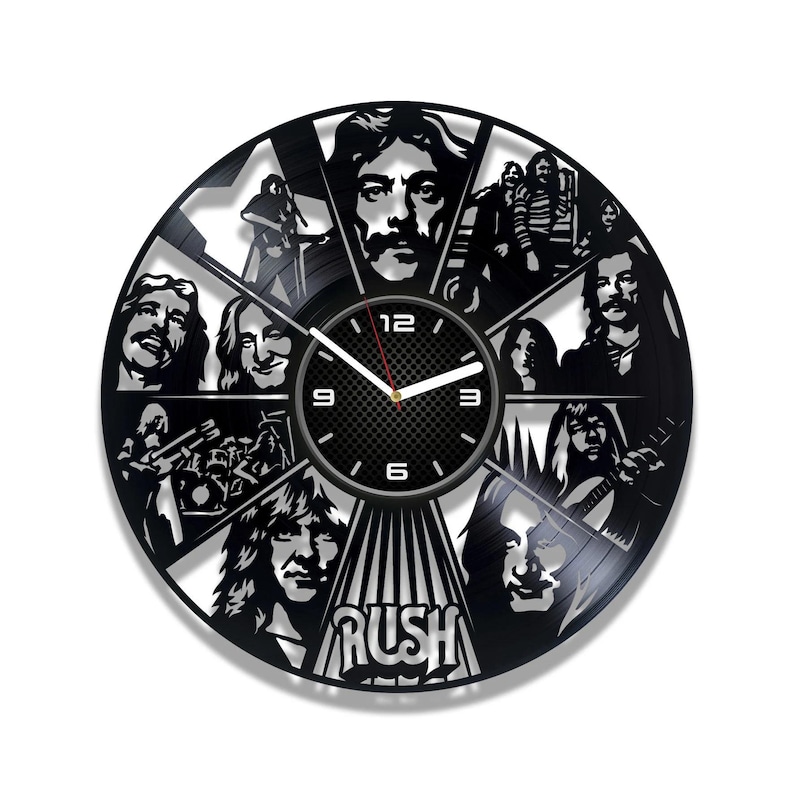 May include: A black vinyl record clock featuring the band Rush. The clock face is a black and white image of the band members, with the band's name "Rush" in white letters at the bottom. The clock hands are black and white.
