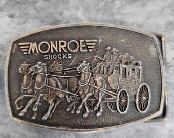 Vintage 1970s MONROE SHOCKS Belt Buckle Auto Car Brasstone Tasco Ind Texas