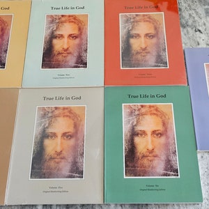 May include: A white ceramic mug with a black handle and the text "But First, Coffee" in a bold, black font. The mug is set against a blurred background, suggesting a cozy setting.