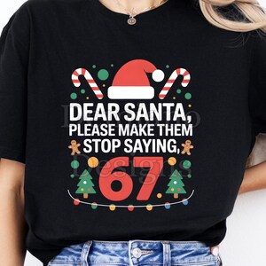 May include: Black t-shirt with a Christmas-themed graphic. The design includes a Santa hat, candy canes, and the text "DEAR SANTA, PLEASE MAKE THEM STOP SAYING, 67." The shirt is a digital file.