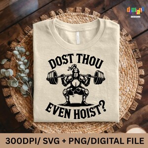 May include: Beige t-shirt with the text "DOST THOU EVEN HOIST?" and a graphic of a knight lifting weights. The design is in black and white. The shirt is displayed on a woven, circular mat.