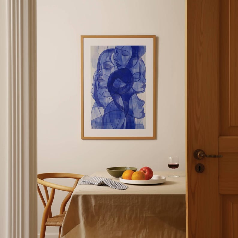 a bowl of fruit sits on a table in front of a painting