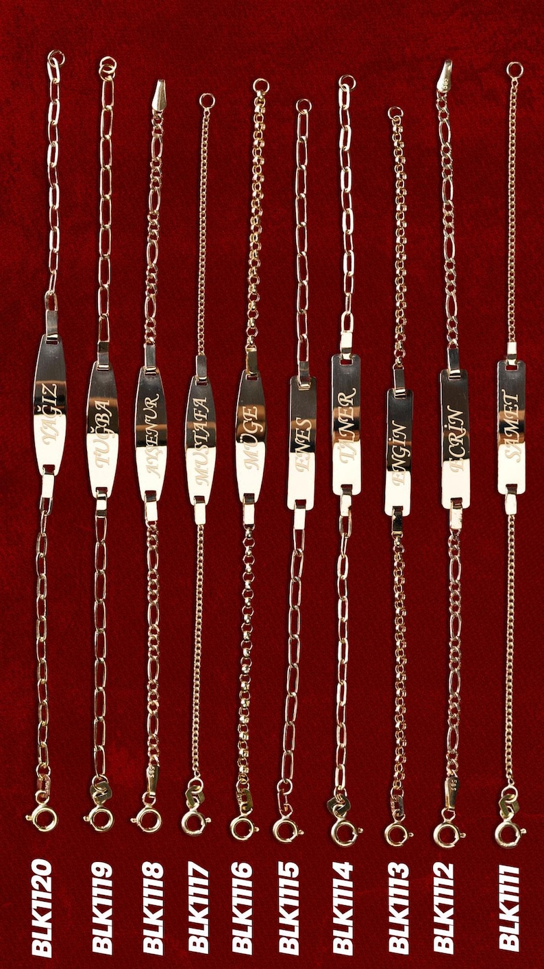 May include: Gold-colored name bracelets with various chain styles. Each bracelet features a rectangular plate with a name engraved on it. The bracelets are displayed against a red background. The image includes the product codes BLK1120 to BLK1111.