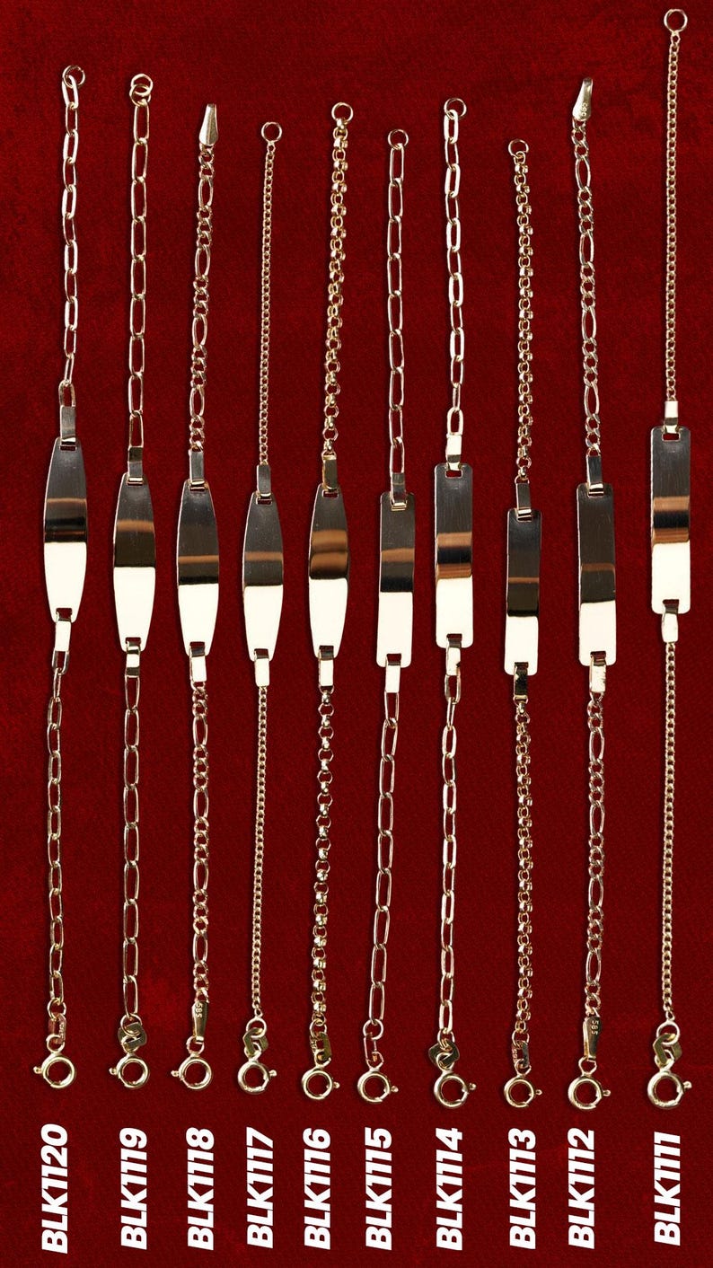 May include: Nine gold-toned bracelets with various chain styles and clasp designs are displayed against a deep red background. Each bracelet features a different chain link pattern, including oval, figaro, and delicate bead chains. Some have rectangular nameplates. The product codes are visible.