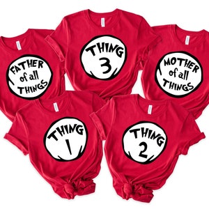 May include: Five red t-shirts with white circles and black text. The shirts say "Father of all things", "Mother of all things", "Thing 1", "Thing 2", and "Thing 3".