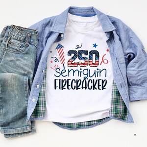 May include: A white t-shirt with the text "250 Semiquin Firecracker" in red, white, and blue, with a blue button-down shirt and blue jeans. The shirt design includes a firework graphic and stars, perfect for Independence Day.