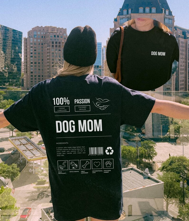 May include: Black t-shirt with a white graphic design that says "100% Passion" and "Dog Mom". The graphic design is a label with a barcode and recycling symbol. The label also includes icons for "Wolf Enthusiast", "Fetch Fanatic", "Treat Obsessed", "Unconditional Love", and "Ever-Loving Parent".