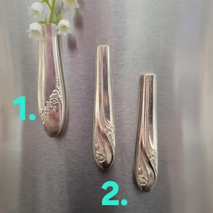 May include: A white ceramic mug with a wraparound design featuring a vibrant, colorful illustration of a toucan bird perched on a branch. The mug has a black handle and a glossy finish.