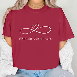 May include: A red t-shirt with a white infinity symbol and a heart in the center. The text "FOREVER AND ALWAYS" is printed below the symbol.