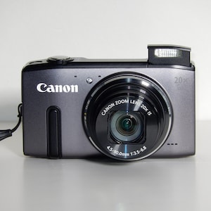 Cámara digital Canon SX270HS Y2K gris de 12,1 MP y zoom óptico de 20x con tarjeta SD, lector de tarjetas SD y cargador.