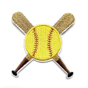 May include: Embroidered patch depicting a yellow softball with red stitching, crossed with two gold baseball bats. The bats have brown handles and black ends. The patch has a white border, suitable for clothing or accessories.
