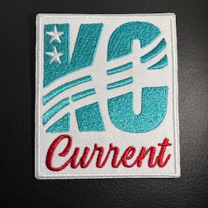 May include: White embroidered patch with the letters "KC" in teal blue with white stars and stripes. The word "Current" is embroidered in red below the letters.