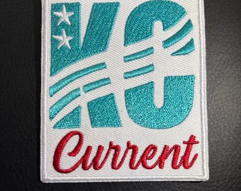 May include: White embroidered patch with the letters "KC" in teal blue with white stars and stripes. The word "Current" is embroidered in red below the letters.