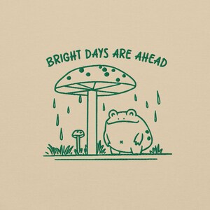 Threadmire © - Get ready to hop into cozy vibes with our Embroidered Cute Frog Under Mushroom Shirt, a whimsical nature tee that’s perfect for animal lovers and those who appreciate positive quotes! This delightful sweatshirt not only keeps you comfy
