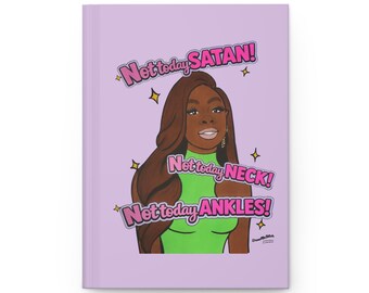 May include: A light purple hardcover journal featuring a cartoon illustration of a person with long brown hair wearing a bright green top. The text reads Not today SATAN! Not today NECK! Not today ANKLES! surrounded by small yellow star accents.