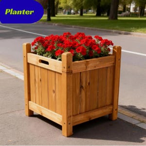 May include: A square wooden planter with a natural light brown finish and vertical slats, featuring a cutout handle on the top rail. The planter is filled with vibrant red flowers with green foliage. The word Planter is visible in the top corner.