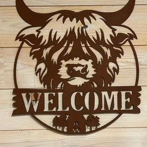 Highland Cow with Barn Welcome Sign