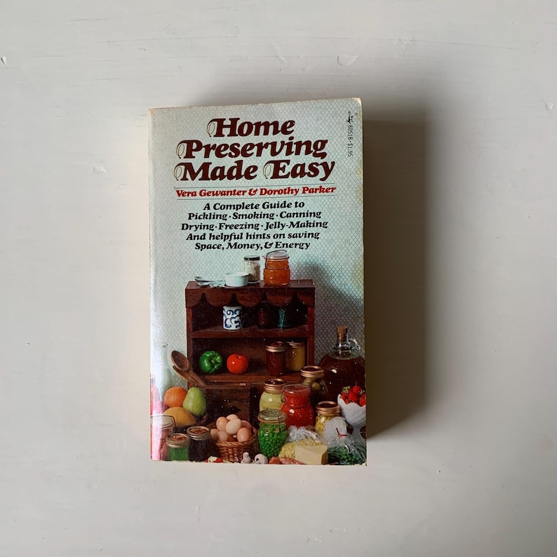 May include: A vintage cookbook titled "Home Preserving Made Easy" by Vera Gewanter & Dorothy Parker. The cover features a colorful illustration of a kitchen shelf stocked with jars of preserved food, fruits, vegetables, and eggs.