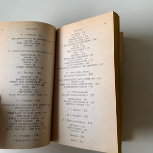 May include: A book with a tan cover and black text. The book is titled "Contents" and lists different food preservation methods, including smoking, pickling, canning, and freezing.
