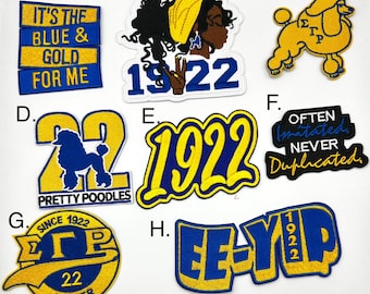 May include: A set of nine embroidered patches in blue and yellow colors. The patches feature various designs, including a woman's profile, a poodle, the number 22, and the letters "EE-YIP".
