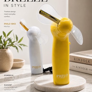 May include: A yellow and white mini fan with clear blades. The fan has the text "PHILO 1943" printed on the handle. The image also includes the text "BREEZE IN STYLE" and "Mini Fan".