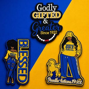 Könnte beinhalten: Gestickte Aufnäher mit Text und Illustrationen. Einer der Aufnäher lautet "Godly GIFTED & Greater Since 1922". Ein anderer sagt "BLESSED" mit einer Figur. Ein dritter Aufnäher zeigt eine Frau und einen Pudel mit dem Text "Poodle-lations 19:22".