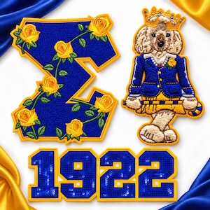 May include: A blue and yellow embroidered patch set featuring the Greek letter Sigma decorated with yellow roses, a teddy bear wearing a crown and blue blazer, and the numbers 1922 in blue sequins with yellow borders.