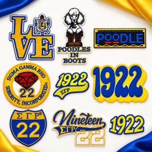 May include: A collection of embroidered patches featuring blue and gold designs, including the text LOVE, POODLES IN BOOTS, POODLE, SIGMA GAMMA RHO SORORITY INCORPORATED, 1922, SGR, and NINETEEN TWENTY TWO, with various shapes and graphic icons.