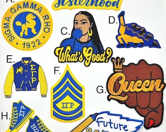 May include: A collection of nine embroidered iron-on patches in various colors and designs. The patches feature text, images, and symbols. Some of the patches include the text "Sisterhood", "What's Good?", "Queen", "Future SGRHO", and "Sigma Gamma Rho 1922".