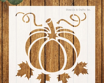 May include: White stencil featuring a pumpkin with a stem, curly vines, and leaves. The stencil is on a wooden background. The text "Stencils & Crafts Inc." is visible in the upper right corner. Ideal for fall crafts.