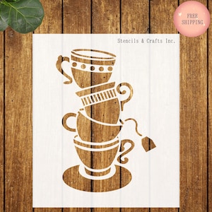 May include: A stencil featuring a stack of teacups with a teabag and saucer. The stencil is white, with the teacups and saucer in a brown color. The text "Stencils & Crafts Inc." is visible.