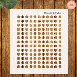 May include: A white stencil with a repeating pattern of evenly spaced, gold-colored circles. The text "Stencils & Crafts Inc." is printed at the top. The stencil is on a wooden background.