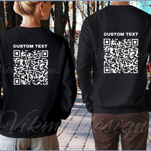 May include: Two black long-sleeved shirts with a white QR code and the text "CUSTOM TEXT" on the back.