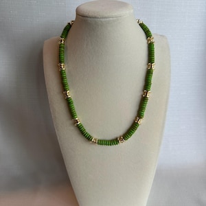Large green and gold beaded necklace with toggle clasp