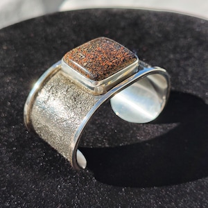 Dino bone sterling silver cuff bracelet size 6-in wrist - 45 CT black petrified dinosaur bone (gembone) bezel set on 1.35 oz textured silver