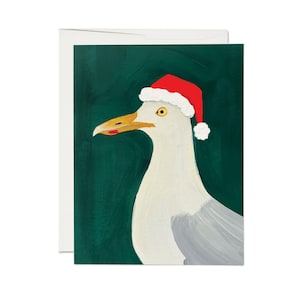 Puede incluir: Una gaviota blanca con un gorro de Papá Noel rojo con ribete blanco sobre un fondo verde oscuro.