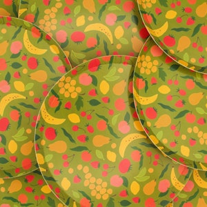 May include: A set of six green and yellow patterned paper plates with a variety of fruit and floral designs. The plates are perfect for a summer party or picnic.