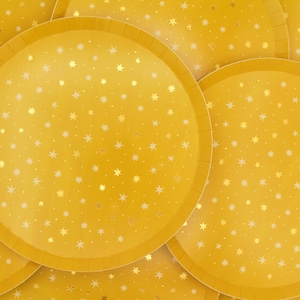 May include: A stack of yellow paper plates with a gold star pattern.