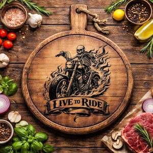 May include: A round wooden cutting board with a handle, featuring a black illustration of a skeleton riding a motorcycle engulfed in flames. The text "LIVE TO RIDE" is below the motorcycle.