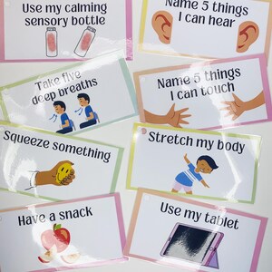 May include: Eight colourful cards with calming activities for children. Each card has a different activity, such as using a sensory bottle, taking deep breaths, squeezing something, stretching, having a snack, or using a tablet. The cards are printed with illustrations and text.