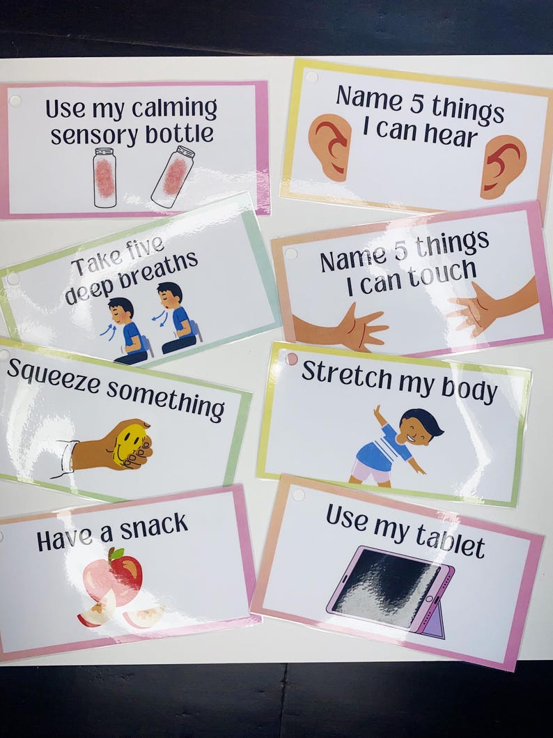 May include: Eight colourful cards with calming activities for children. Each card has a different activity, such as using a sensory bottle, taking deep breaths, squeezing something, stretching, having a snack, or using a tablet. The cards are printed with illustrations and text.