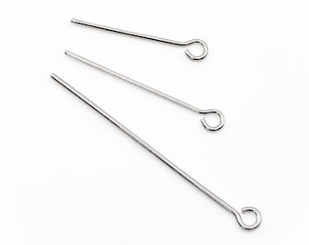 May include: Three silver head pins with loops at the end. The head pins are different lengths.