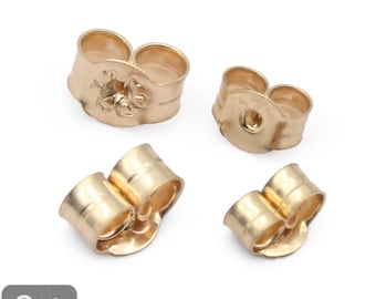Puede incluir: Cuatro respaldos de pendientes de color dorado. Los respaldos son de metal y tienen un acabado liso. 9ct Oro sólido.